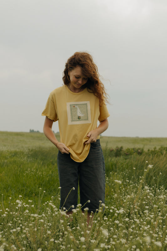 Goose patched yellow tee